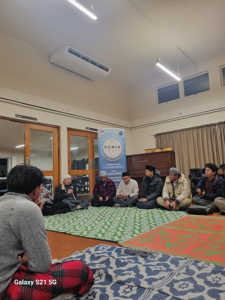 A HUMIA gathering with community members seated together in a hall